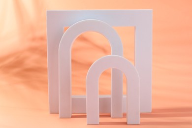 Photo of Promotion. Different white figures on coral background