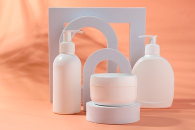 Photo of Promotion. Cosmetic products and podiums on color background