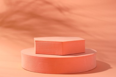 Photo of Promotion. Podiums for product presentation on coral background