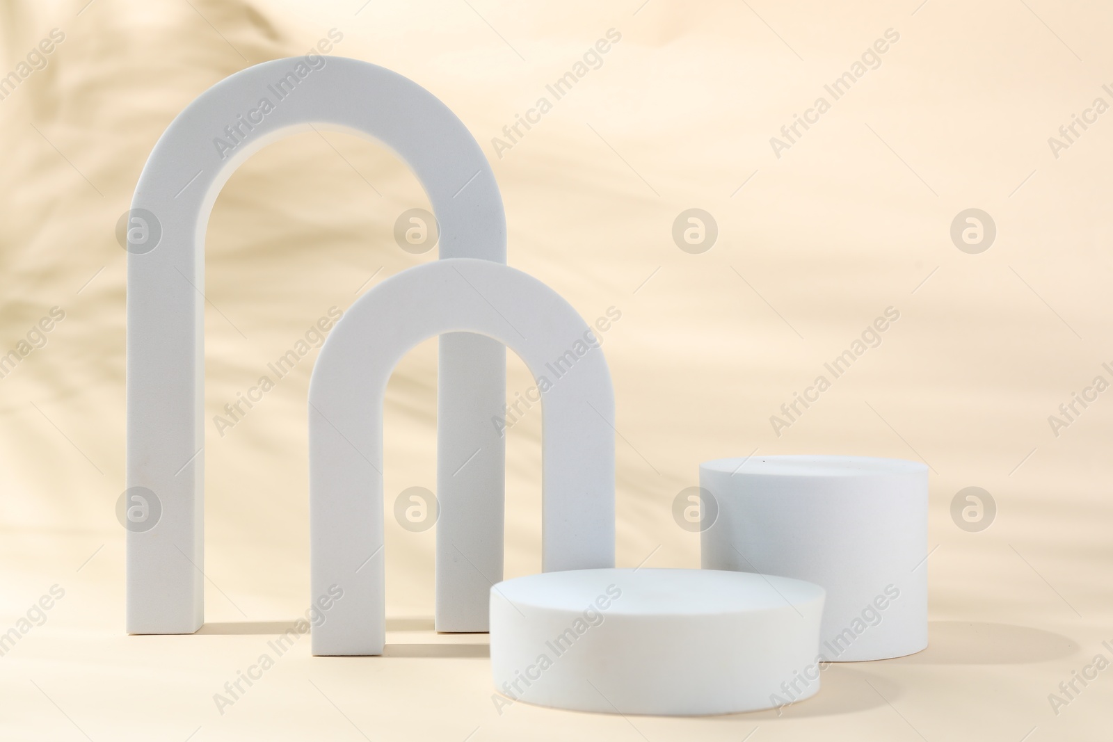 Photo of Promotion. Different podiums for product presentation on beige background