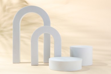 Photo of Promotion. Different podiums for product presentation on beige background