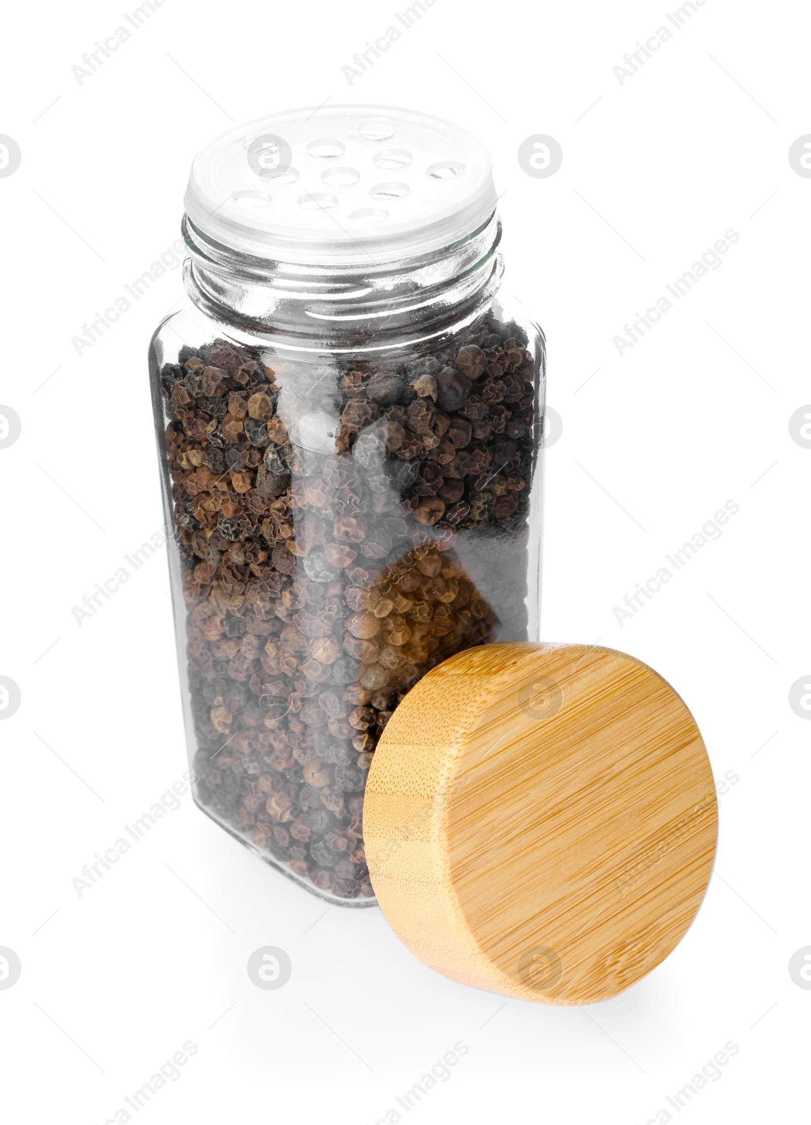 Photo of Peppercorns in glass jar isolated on white. Aromatic spice
