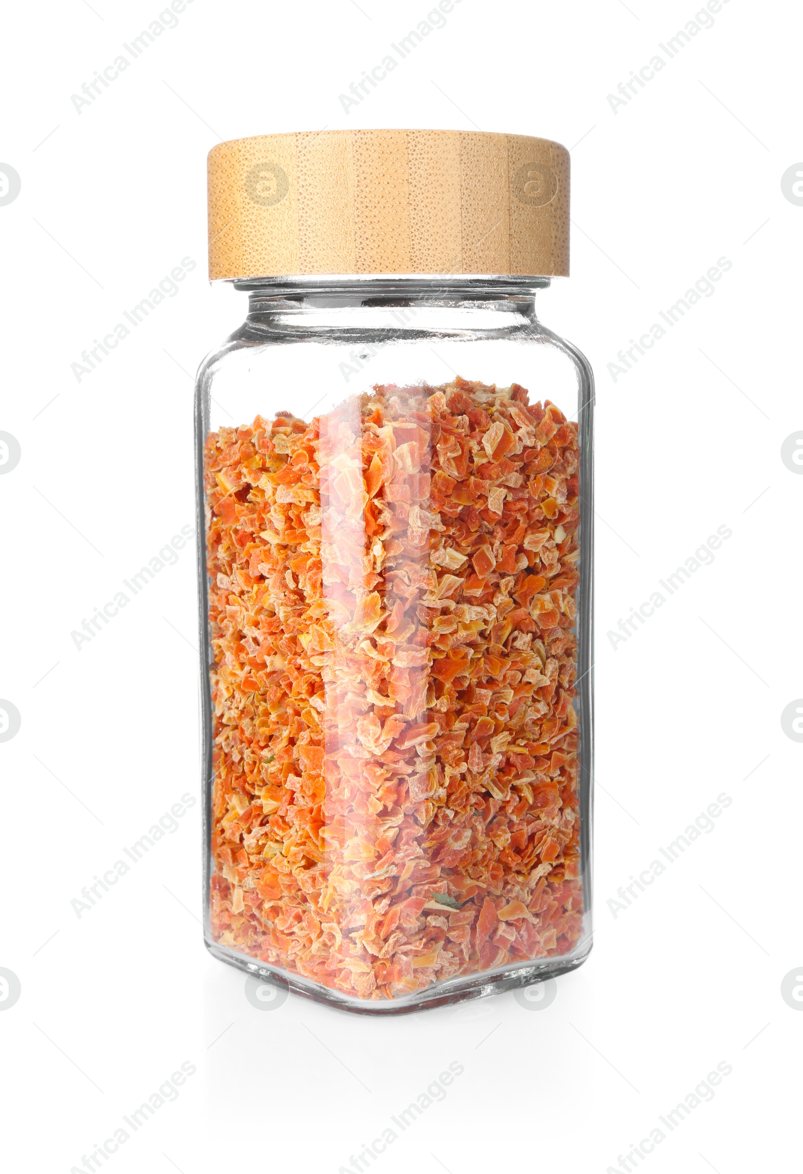 Photo of Dried carrots in glass jar isolated on white. Aromatic spice