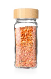 Photo of Dried carrots in glass jar isolated on white. Aromatic spice