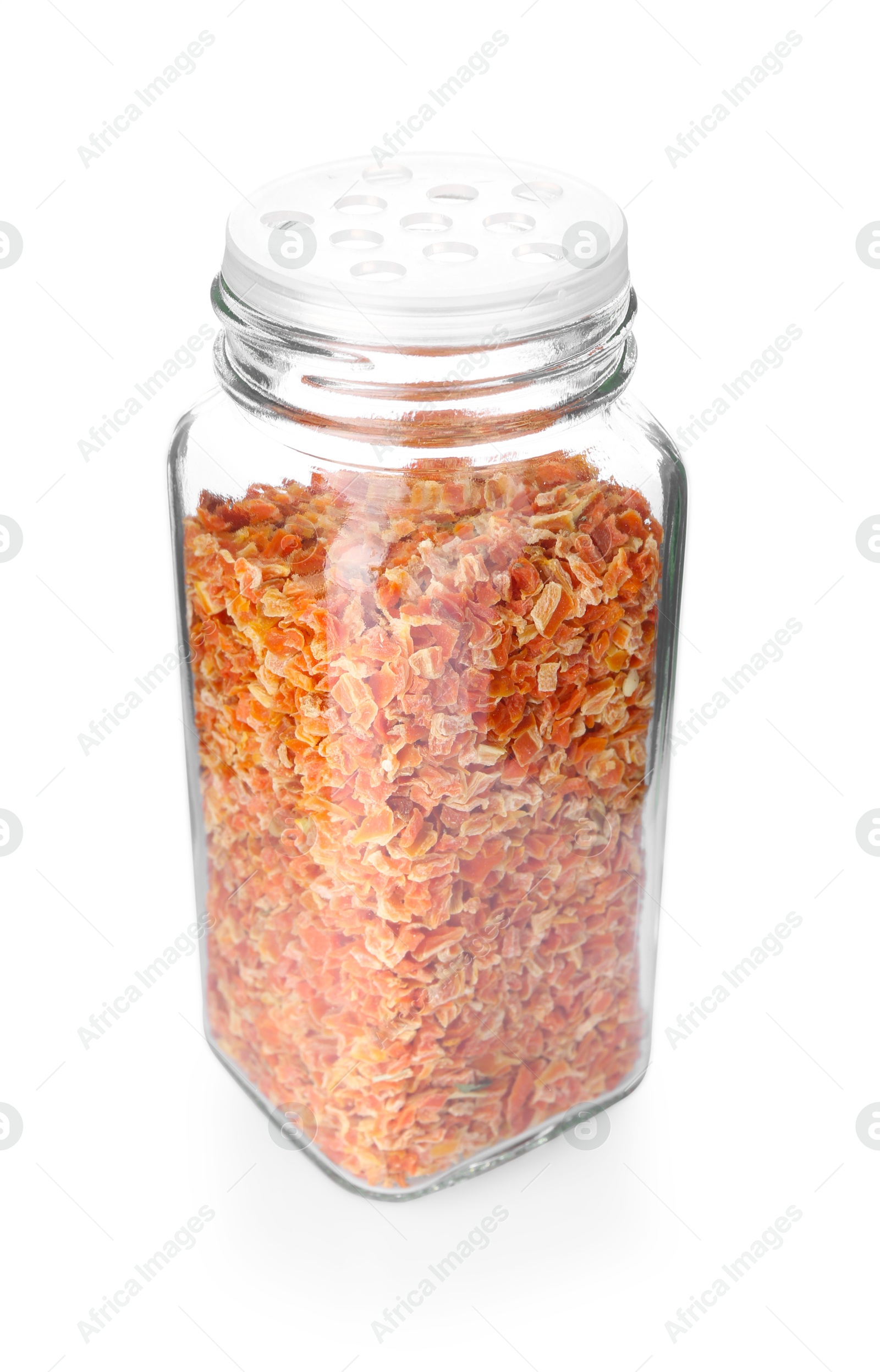 Photo of Dried carrots in glass jar isolated on white. Aromatic spice