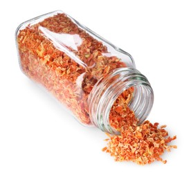 Photo of Dried carrots in glass jar isolated on white. Aromatic spice