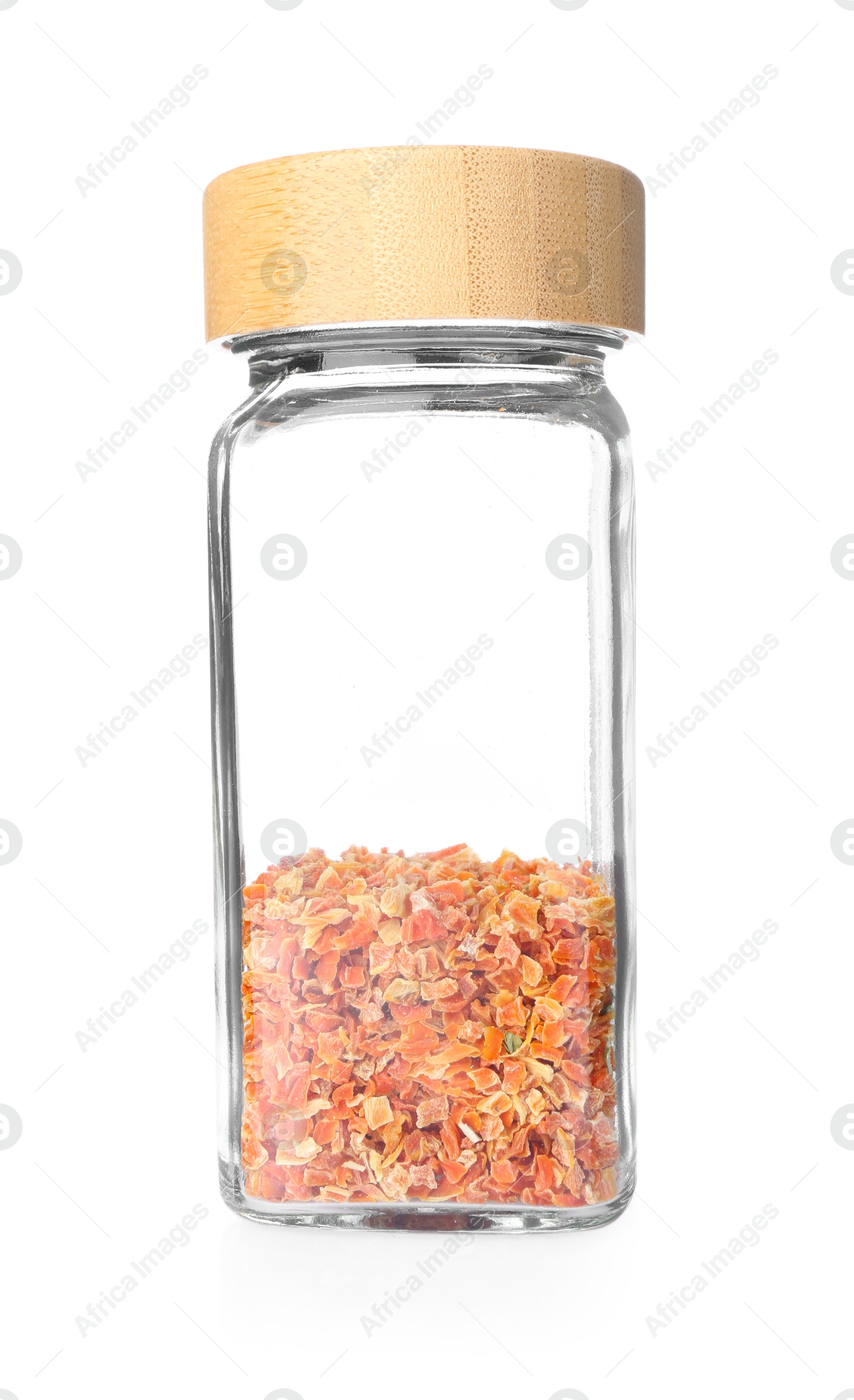Photo of Dried carrots in glass jar isolated on white. Aromatic spice