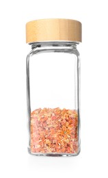 Photo of Dried carrots in glass jar isolated on white. Aromatic spice