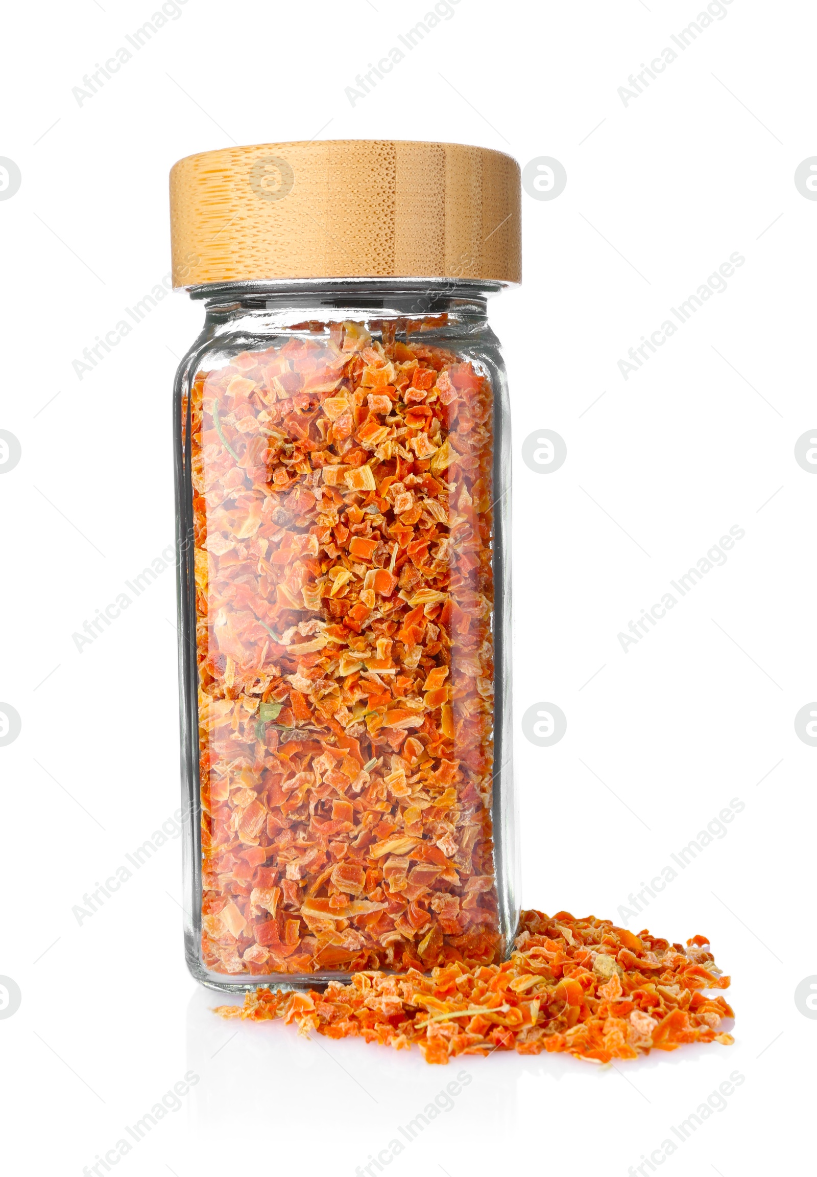 Photo of Dried carrots in glass jar isolated on white. Aromatic spice