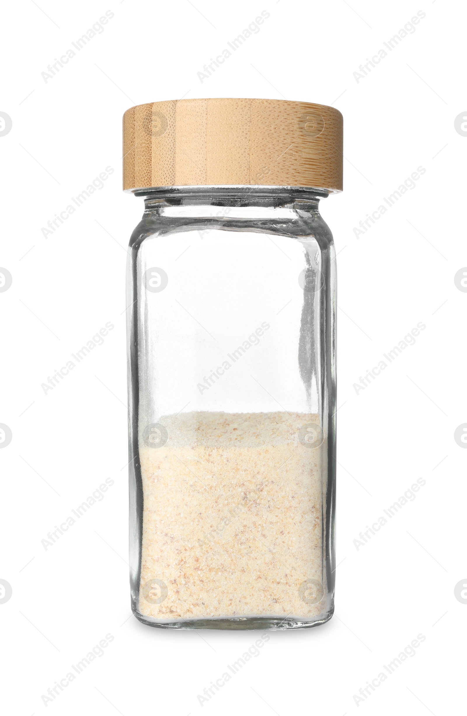 Photo of Garlic powder in glass jar isolated on white. Aromatic spice