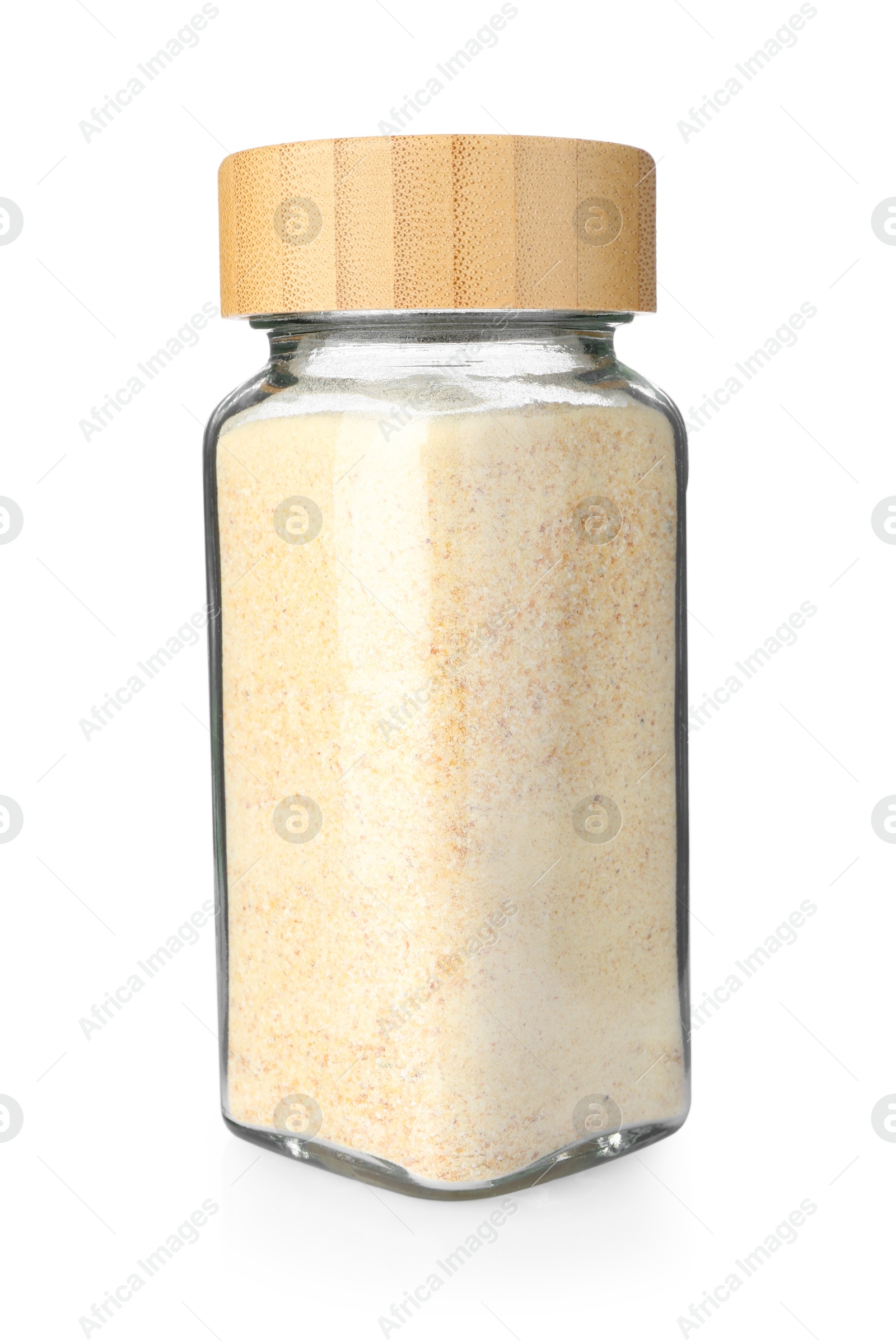 Photo of Garlic powder in glass jar isolated on white. Aromatic spice