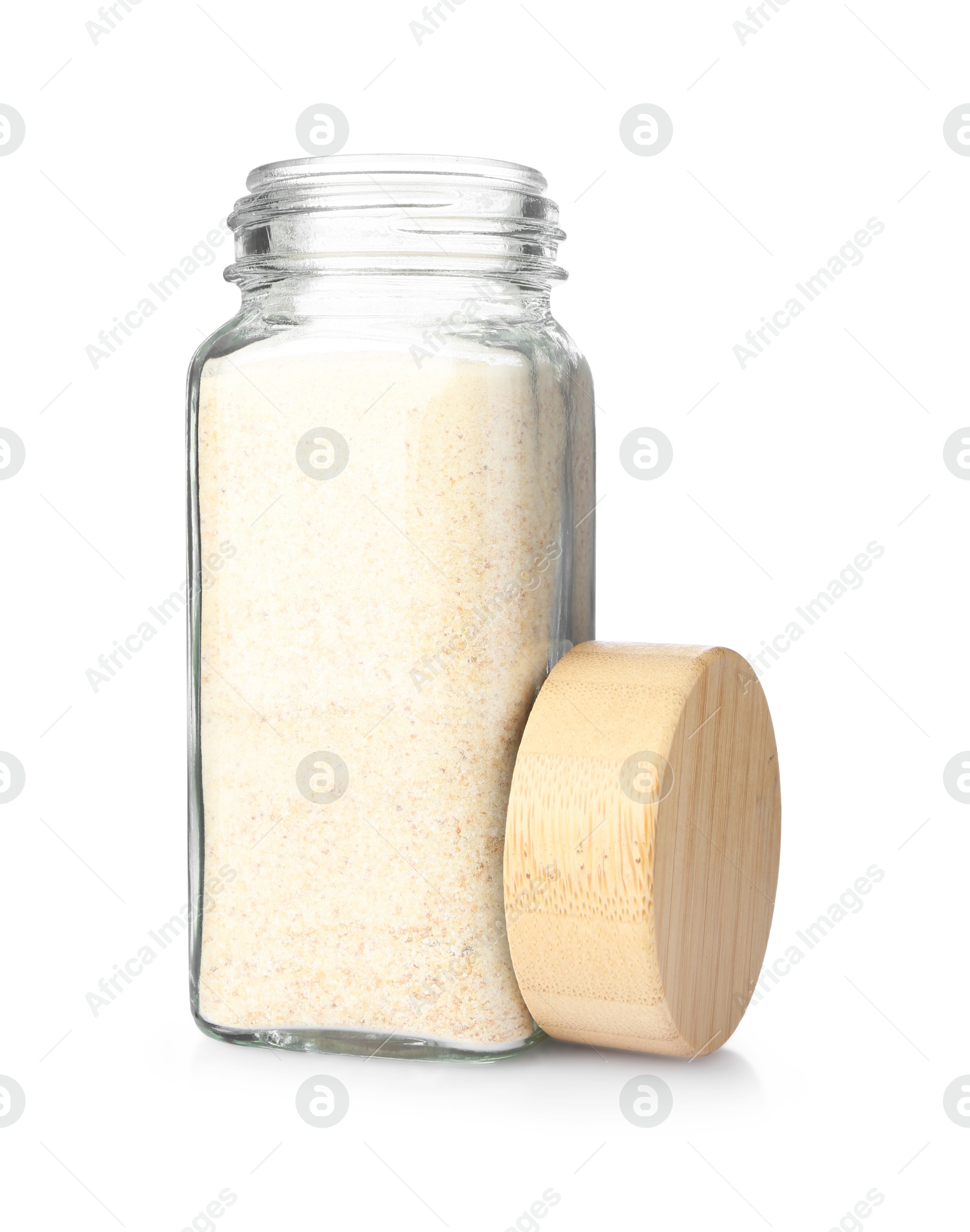 Photo of Garlic powder in glass jar isolated on white. Aromatic spice
