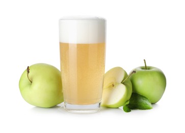 Photo of Tasty cider in glass, fresh apples and green leaves isolated on white