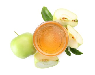 Photo of Tasty cider in glass, fresh apples and green leaves isolated on white, top view