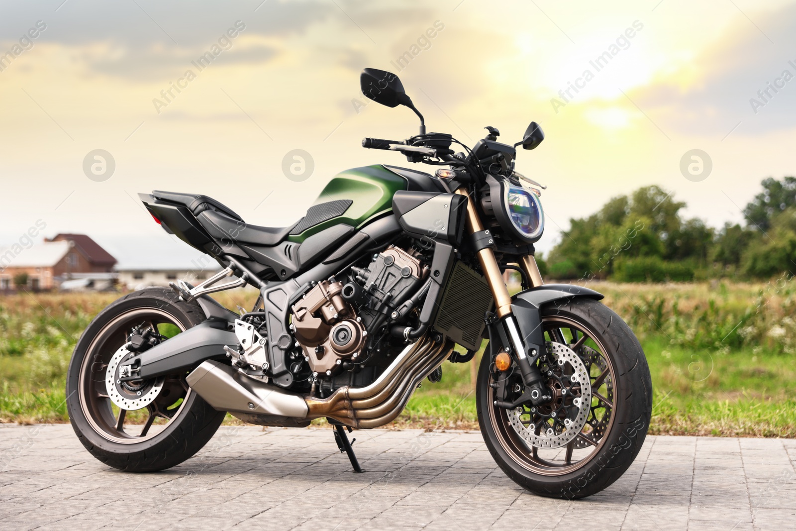 Modern black motorcycle parked on road outdoors Photo of Modern black motorcycle parked on road outdoors