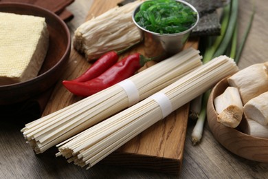 Photo of Enoki, king oyster (eryngii) mushrooms and other ingredients for ramen on table, closeup
