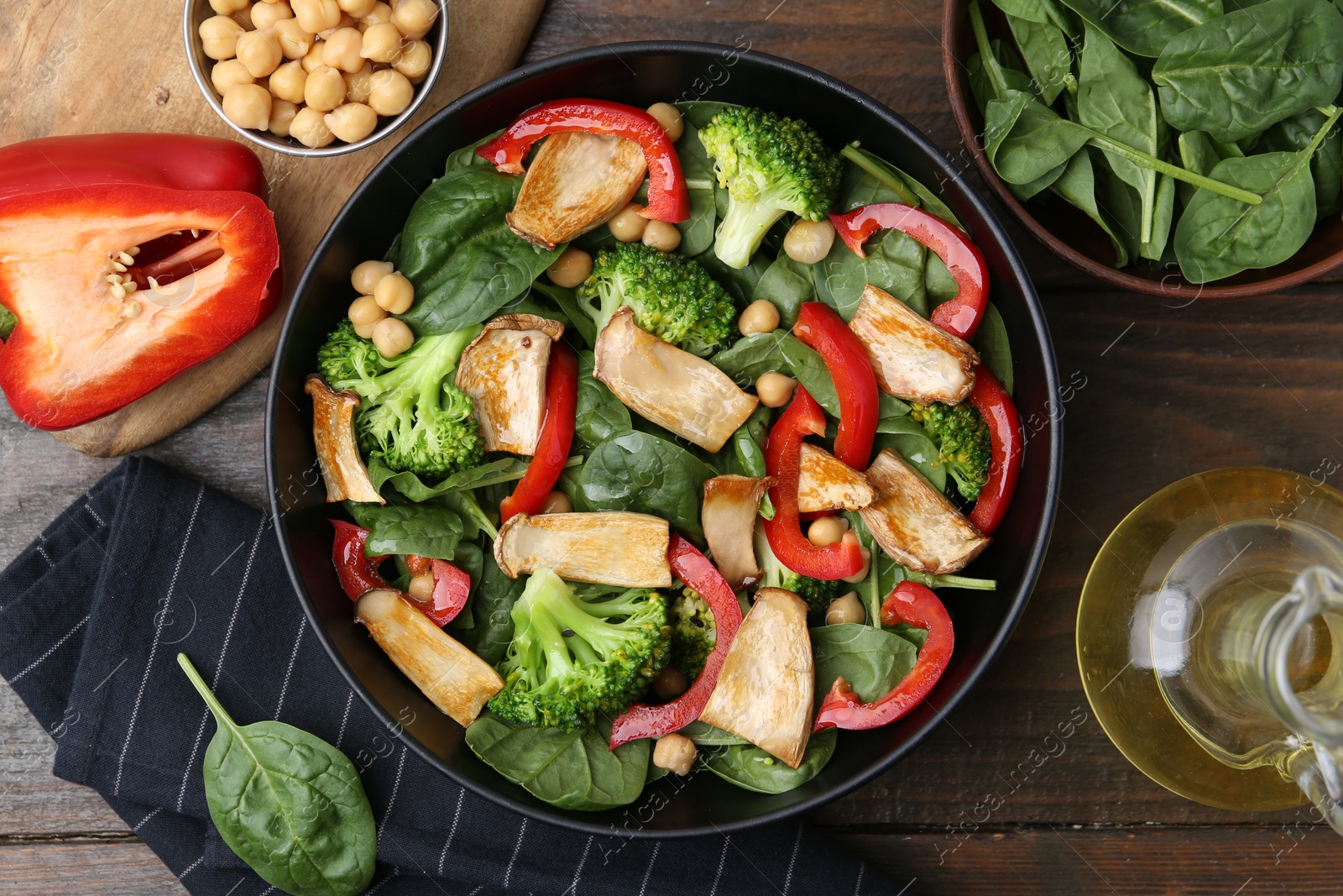Tasty salad with eryngium mushrooms served on wooden table, flat lay Photo of Tasty salad with eryngium mushrooms served on wooden table, flat lay