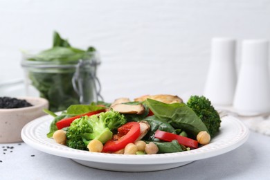 Photo of Tasty salad with eryngium mushrooms served on light table, closeup