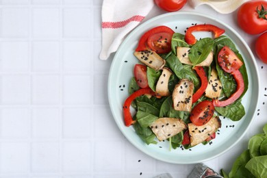 Photo of Tasty salad with eryngium mushrooms served on white tiled table, flat lay. Space for text