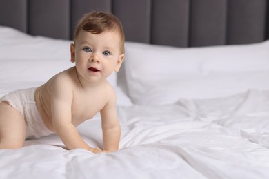 Photo of Cute little baby on bed indoors, space for text