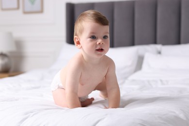 Photo of Cute little baby on bed at home