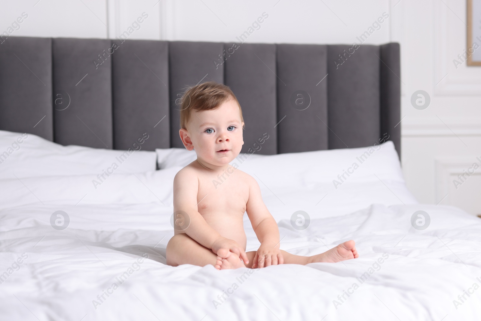 Photo of Cute little baby on bed at home