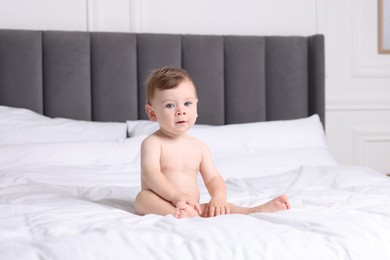 Photo of Cute little baby on bed at home