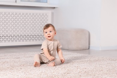 Photo of Cute little baby on floor at home, space for text