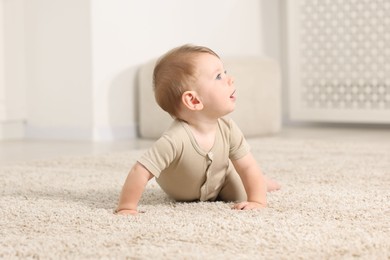 Photo of Cute little baby on floor at home