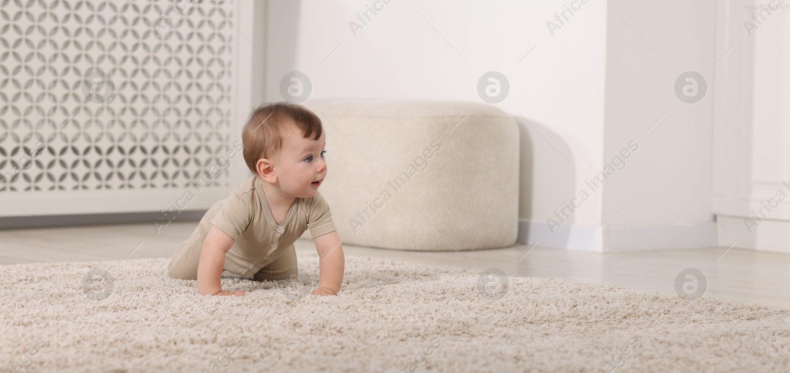 Photo of Cute little baby on floor at home, space for text