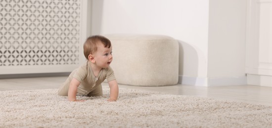 Photo of Cute little baby on floor at home, space for text