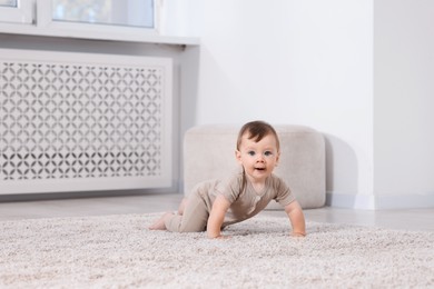 Photo of Cute little baby on floor at home