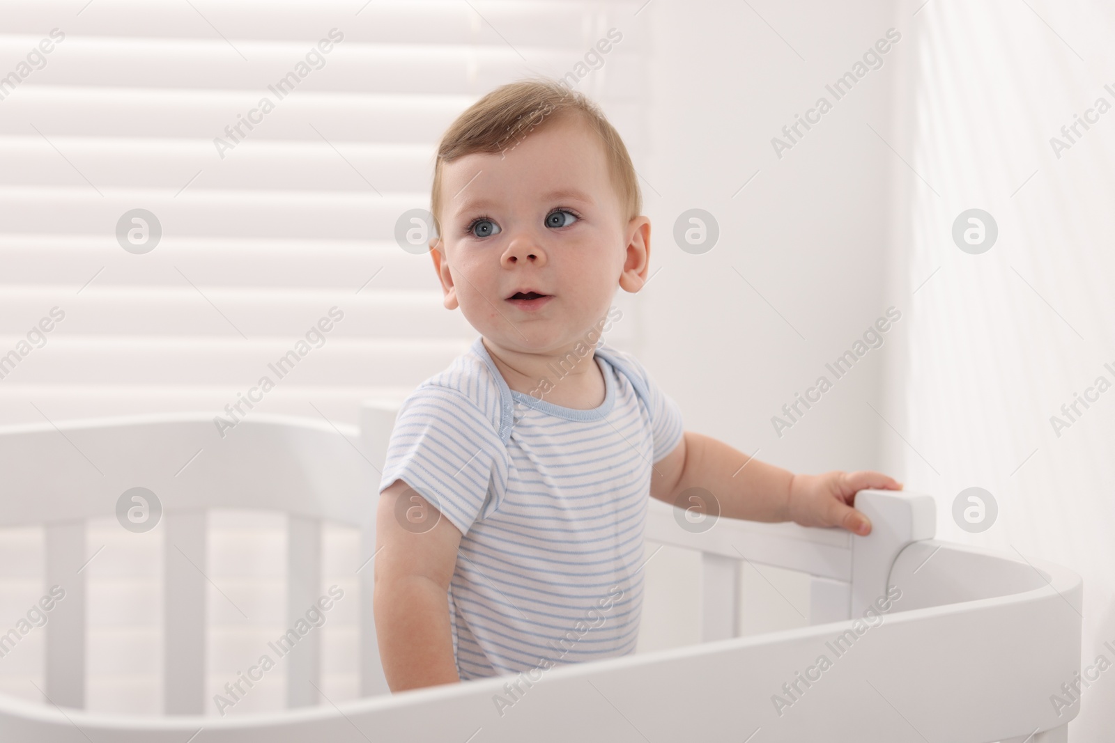 Photo of Cute little baby in crib at home