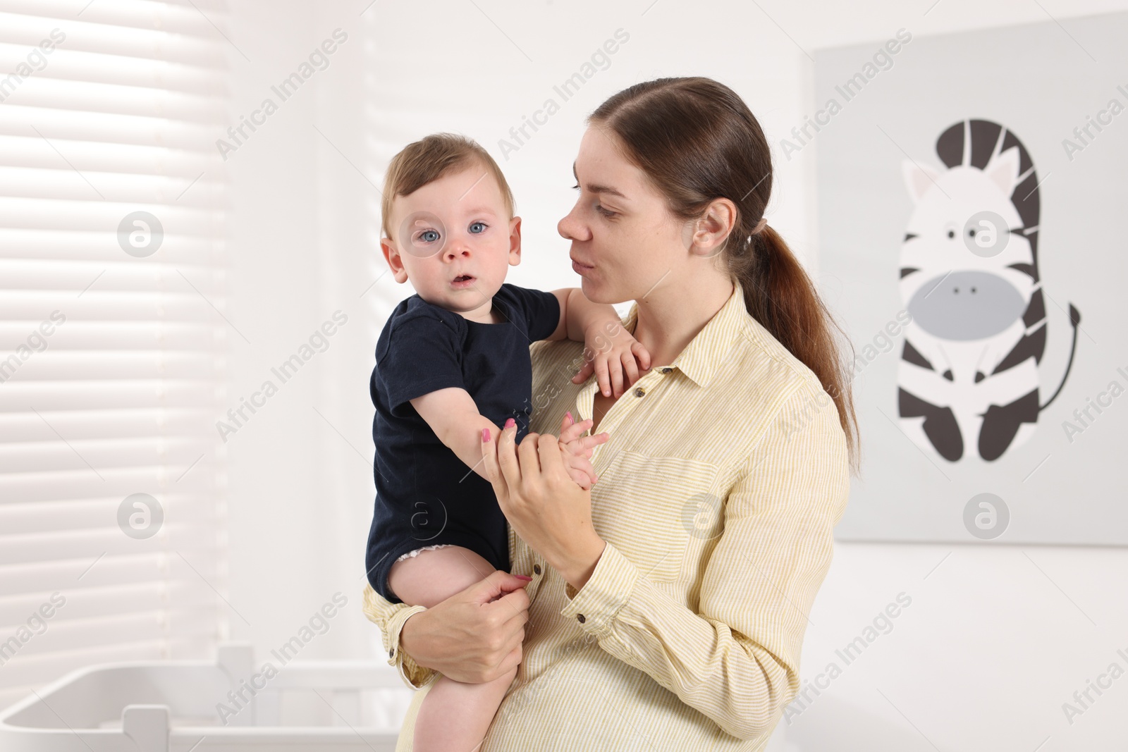 Photo of Mother with her cute little baby at home