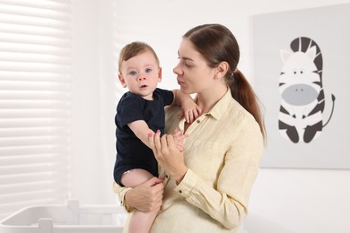 Photo of Mother with her cute little baby at home