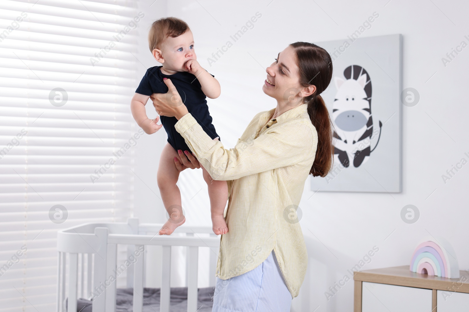 Photo of Mother with her cute little baby at home