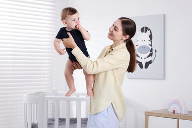 Photo of Mother with her cute little baby at home