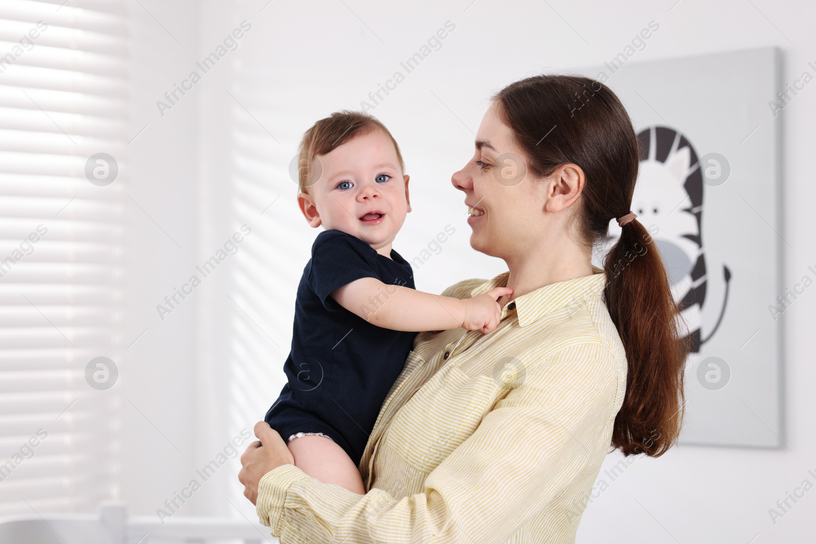 Photo of Mother with her cute little baby at home, space for text