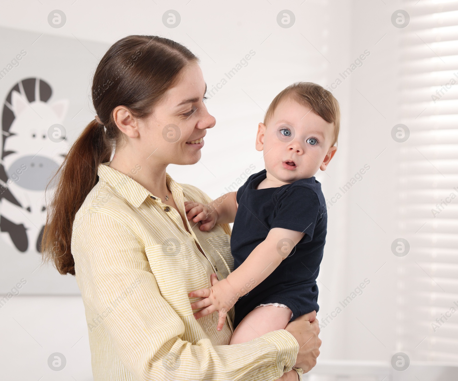 Photo of Mother with her cute little baby at home