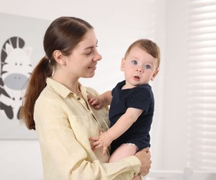 Photo of Mother with her cute little baby at home