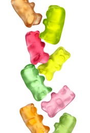 Image of Sweet jelly candies in shape of bear falling against white background