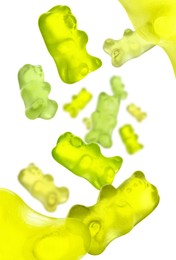 Image of Sweet jelly candies in shape of bear falling against white background