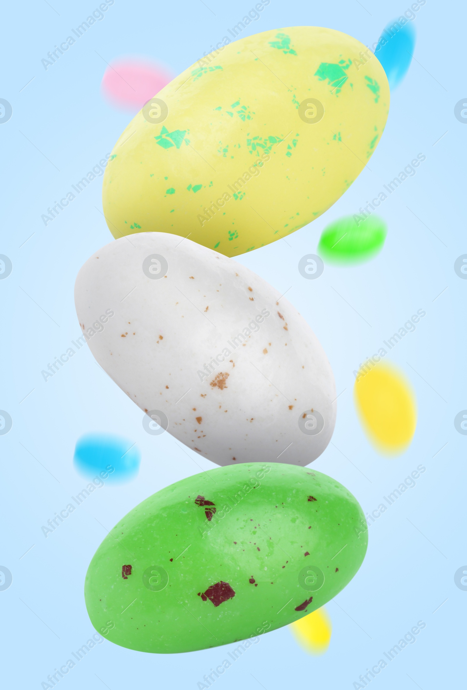 Image of Sweet jelly beans falling against light blue background