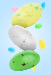 Image of Sweet jelly beans falling against light blue background