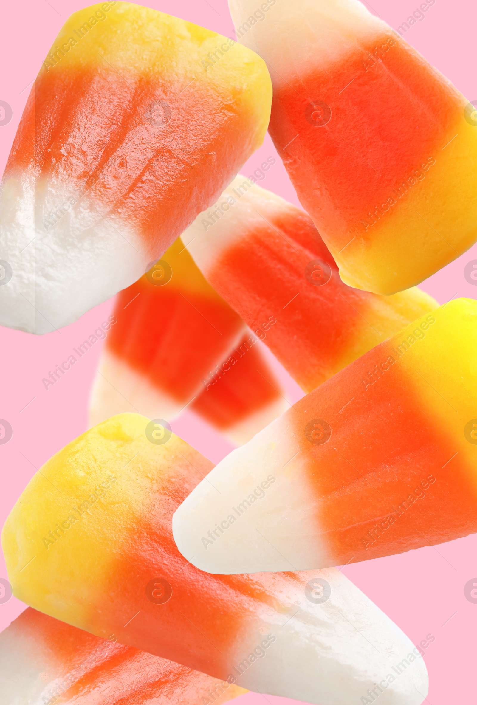 Image of Sweet jelly candies falling against pink background
