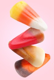 Image of Sweet jelly candies falling against pink background