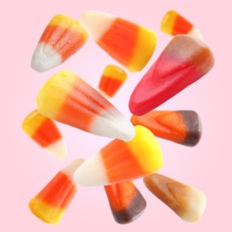 Image of Sweet jelly candies falling against pink background
