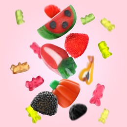 Image of Sweet jelly candies falling against pink background