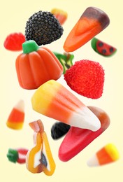 Image of Sweet jelly candies falling against beige background