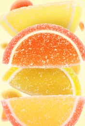 Image of Sweet jelly candies falling against beige background